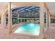 Inviting pool and spa area with a covered patio and lounge chairs at 817 Hail Ct, Port Orange, FL 32127