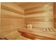 Relax in this private, wood-paneled sauna, complete with a bucket and bench at 817 Hail Ct, Port Orange, FL 32127