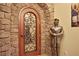 Elegant wine cellar with stone walls and wrought iron door at 817 Hail Ct, Port Orange, FL 32127