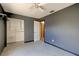 Bedroom with gray walls, ceiling fan, and a closet at 84 Tumbler Dr, Port Orange, FL 32129