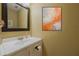 Small bathroom with vanity, mirror, and modern art at 980 Canal View Blvd # C7, Port Orange, FL 32129