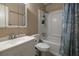 Clean bathroom with a tub shower, vanity, and seashell decor at 980 Canal View Blvd # C7, Port Orange, FL 32129