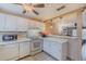 Well-equipped kitchen featuring white cabinets and a breakfast bar at 980 Canal View Blvd # C7, Port Orange, FL 32129