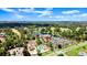 Aerial view showcasing lush surroundings with pool, lake, and community center at 105 Wood Duck Cir # 1C, Daytona Beach, FL 32119