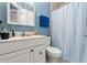 Clean bathroom with white vanity, shower/tub combo and blue walls at 105 Wood Duck Cir # 1C, Daytona Beach, FL 32119