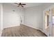 This bedroom boasts a ceiling fan, neutral walls, and double doors that lead to the porch at 105 Wood Duck Cir # 1C, Daytona Beach, FL 32119