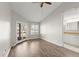 Well-lit bedroom featuring hardwood floors, a ceiling fan, and ensuite bath at 105 Wood Duck Cir # 1C, Daytona Beach, FL 32119
