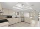 Well-lit kitchen with white cabinets, stainless dishwasher, and a garden window at 105 Wood Duck Cir # 1C, Daytona Beach, FL 32119