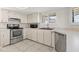 Kitchen with stainless appliances, tile backsplash, and ample counter space at 105 Wood Duck Cir # 1C, Daytona Beach, FL 32119