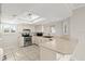 Cozy kitchen features a breakfast bar with updated appliances and countertops at 105 Wood Duck Cir # 1C, Daytona Beach, FL 32119