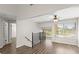 Cozy loft area with iron railing overlooking the living area below, a ceiling fan, and bright windows at 105 Wood Duck Cir # 1C, Daytona Beach, FL 32119