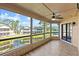 A screened in porch overlooking a pond and features a ceiling fan for added comfort at 105 Wood Duck Cir # 1C, Daytona Beach, FL 32119