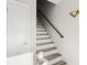 Bright staircase featuring wooden steps and a modern railing at 105 Wood Duck Cir # 1C, Daytona Beach, FL 32119