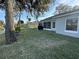 Spacious backyard featuring a lush lawn, a waterfront view, and a grill at 107 Old Sunbeam Dr, South Daytona, FL 32119