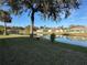 Scenic backyard featuring a lush lawn and a tranquil waterfront view at 107 Old Sunbeam Dr, South Daytona, FL 32119