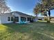 Spacious backyard with screened lanai, grill, and comfortable seating provides an ideal outdoor living space at 107 Old Sunbeam Dr, South Daytona, FL 32119