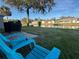 Relaxing backyard with water view, complete with lawn chairs and a grill at 107 Old Sunbeam Dr, South Daytona, FL 32119