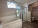 Bathroom with soaking tub and glass shower at 107 Old Sunbeam Dr, South Daytona, FL 32119