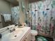 Beach-themed bathroom with flip-flop shower curtain and decorative accents at 107 Old Sunbeam Dr, South Daytona, FL 32119