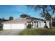 Attractive single-story home with three-car garage, landscaped yard, and a welcoming front entrance at 107 Old Sunbeam Dr, South Daytona, FL 32119