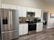 Bright kitchen with stainless steel appliances, granite countertops, and neutral flooring at 107 Old Sunbeam Dr, South Daytona, FL 32119