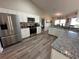 Modern kitchen featuring stainless steel appliances, granite countertops, and white cabinets at 107 Old Sunbeam Dr, South Daytona, FL 32119