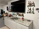 Garage wet bar featuring bar with granite counters and decorative liquor bottle displays at 107 Old Sunbeam Dr, South Daytona, FL 32119