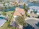 Aerial view of waterfront home with private dock and lush landscaping at 107 Via Amalfi, New Smyrna Beach, FL 32169