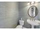 Powder room features pedestal sink and textured wallcovering at 107 Via Amalfi, New Smyrna Beach, FL 32169