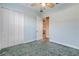 Empty bedroom with carpet, ceiling fan, and double doors leading to another room at 107 Via Amalfi, New Smyrna Beach, FL 32169