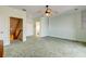 Bedroom with carpet, ceiling fan, and access to upper level and bathroom at 107 Via Amalfi, New Smyrna Beach, FL 32169