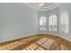 Light and airy bedroom with wood flooring and arched windows at 107 Via Amalfi, New Smyrna Beach, FL 32169