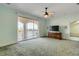 Spacious bedroom with water views, balcony access, and ceiling fan at 107 Via Amalfi, New Smyrna Beach, FL 32169