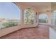 Bright enclosed patio with tiled floors and arched windows at 107 Via Amalfi, New Smyrna Beach, FL 32169