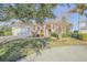 House exterior showcasing a Mediterranean style home with lush landscaping at 107 Via Amalfi, New Smyrna Beach, FL 32169