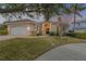 Single-story home with a two-car garage and mature landscaping at 107 Via Amalfi, New Smyrna Beach, FL 32169