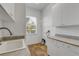 Laundry room with utility sink, cabinets, and tiled floor at 107 Via Amalfi, New Smyrna Beach, FL 32169