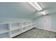 Unfinished attic room with overhead lighting and shelving at 107 Via Amalfi, New Smyrna Beach, FL 32169