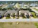 Aerial view of community showing multiple tan houses with garages at 108 Tuscany Villas Dr # 108, Edgewater, FL 32141