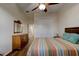 Bedroom with wood flooring, ceiling fan, and striped bedding at 108 Tuscany Villas Dr # 15, Edgewater, FL 32141