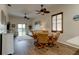 Dining room features hardwood floors, ceiling fan, and seating for four at 108 Tuscany Villas Dr # 108, Edgewater, FL 32141