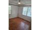 Simple bedroom with hardwood floors and two windows at 1132 Australia Ave, Daytona Beach, FL 32114