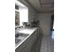 Kitchen with white cabinets, black and white tile floor at 1132 Australia Ave, Daytona Beach, FL 32114