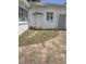 Small patio area with overgrown weeds at 1132 Australia Ave, Daytona Beach, FL 32114