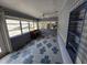 Sunroom with tiled floor, piano, and built-in shelving at 1132 Australia Ave, Daytona Beach, FL 32114