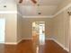 Open living room showcasing the hardwood floors, trim, and connection to the kitchen at 115 E Turgot, Edgewater, FL 32132