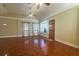 Bright living room with gleaming hardwood floors, a bay window, and a ceiling fan at 115 E Turgot, Edgewater, FL 32132