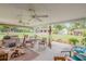 Spacious covered patio with ceiling fans, an outdoor dining area, and views of the backyard at 115 E Turgot, Edgewater, FL 32132