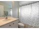 Small bathroom with a shower/tub combo, vanity, and white cabinets at 1155 Kilkenny Ln, Ormond Beach, FL 32174