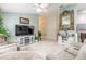 Open living area with a large TV, comfy seating, and a decorative mirror at 1155 Kilkenny Ln, Ormond Beach, FL 32174